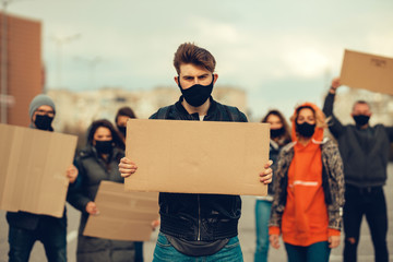 A group of people with mask and posters to protest The protest of the population against...