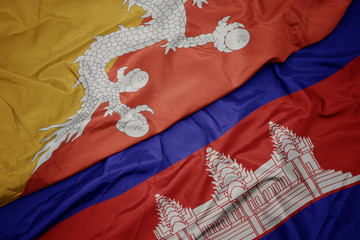 waving colorful flag of cambodia and national flag of bhutan.