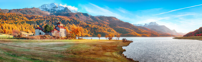 Fantastic autumn view of Crap da Sass castle on Silvaplana lake.