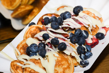Street food dessert: waffles and small dutch pancakes