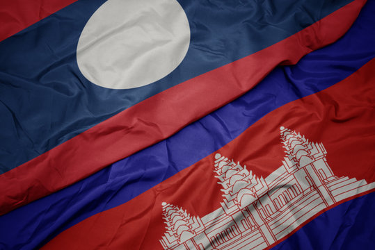 waving colorful flag of cambodia and national flag of laos.