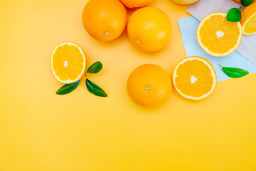 Orange juice with oranges on yellow background