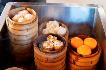 the dim sum being steamed in a steamer