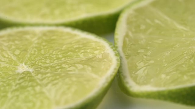Lime slices closeup, macro food summer background, fruits top view. Rotate