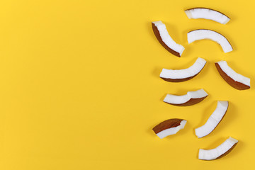Coconut fruit slices on right side of yellow background with blank copy space