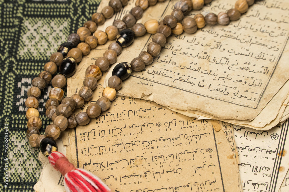 Sticker muslim prayer beads with ancient pages from the koran. islamic and muslim concepts. ancient old shee