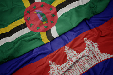 waving colorful flag of cambodia and national flag of dominica.