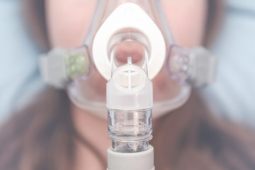 oxygen mask on the girl's face. resuscitation concept. treatment of respiratory failure and...