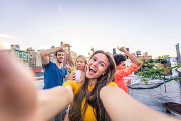 Fototapeta na wymiar Group of friends having party on a rooftop