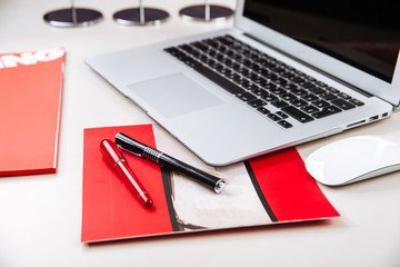 Office workplace with a laptop pen mouse on table
