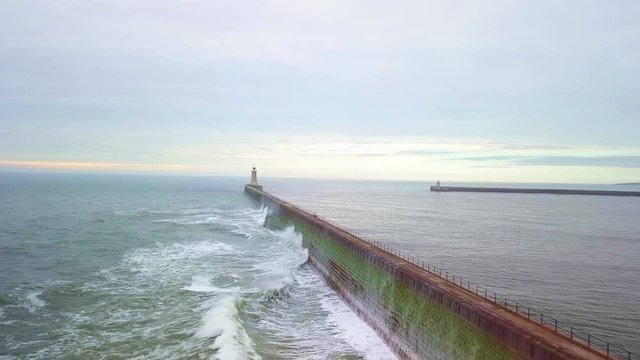 Waves Crashing on Tynemouth Pier - Low flying sweeping 4k drone shot