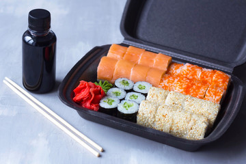sushi delivery, home delivery in plastic and paper packaging, contactless delivery during the coronavirus epidemic