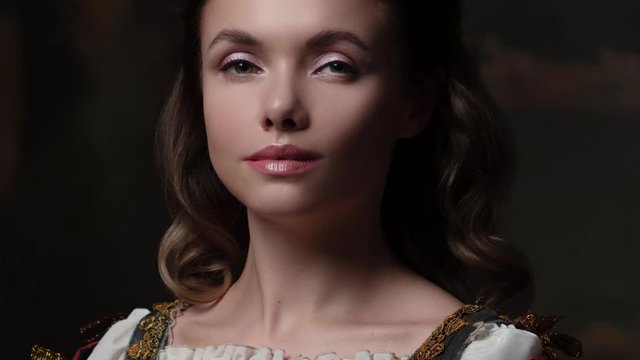 Portrait of a young woman in the style of a Renaissance painting. Beautiful mysterious girl in medieval dress