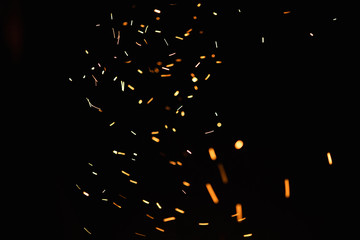 Group of flying sparks in the black background