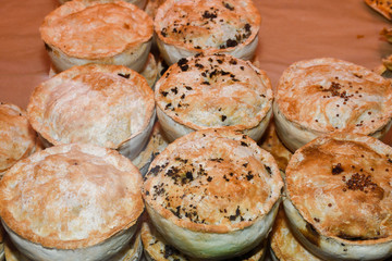 British pie stuffed in display window, for sale