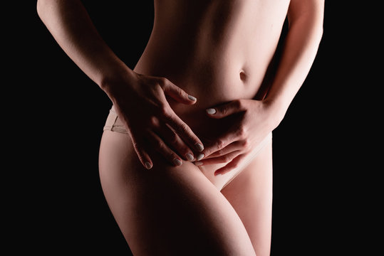 Beautiful young girl body on a dark background, the concept of a healthy, slim and well-groomed body Happy family together with a dog lie on a large bed indoors.