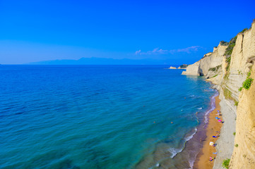 Loggas beach at Peroulades is a paradise beach at  high rocky white cliff and crystal clear azure water in Corfu, close to Cape Drastis, Ionian island, Greece, Europe