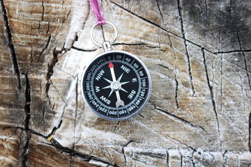 Fototapeta na wymiar Old iron compass on tree in forest