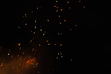 Group of flying sparks in the black background
