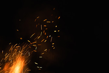 Group of flying sparks in the black background