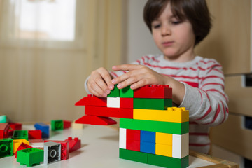 child plays with toy constructions