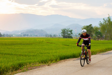 Fototapeta na wymiar Asian men ride on a mountain bike. Sport and active life concept.