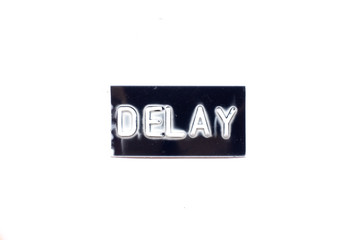 Embossed letter in word delay in black banner on white background