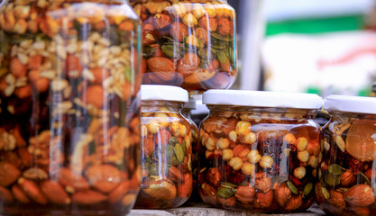 Various types of nuts in honey jars