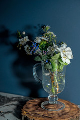 A light bouquet of spring flowers, and a shadow on the wall.