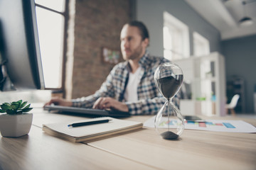 Blurry focus photo of handsome business guy look computer monitor sand clock on table chatting boss promise finish report in time wear casual shirt suit sitting chair office indoors - obrazy, fototapety, plakaty