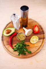 sauce and ingredients included in it on a wooden board