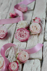 Background gray bricks, pink roses with satin ribbon