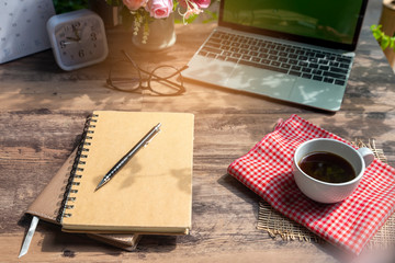 Calendar and Laptop for Planner to plan reminder daily appointment timetable,appointment,organization and meeting agenda of job on wooden desk,work from home.Cup of coffee book computer place on table