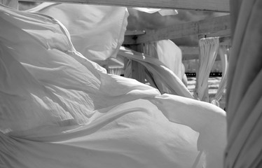 Windy beach. Stormy clouds in the sky and white sheets torn by the wind.