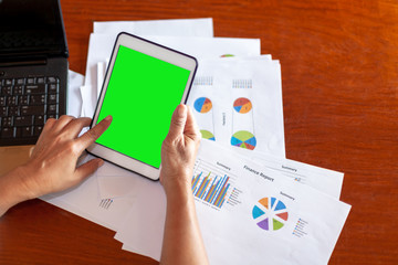 Woman hand working with document and  phone on tabel in concept  Making money at home  on the Internet with a green screen for  used for your best content