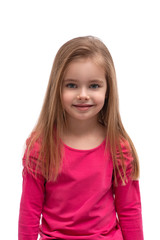 Studio shot of a cute blonde smiling girl with long hair and blue eyes, isolated