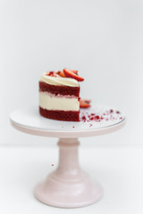 Delicious homemade red velvet cake with fresh berries on white background