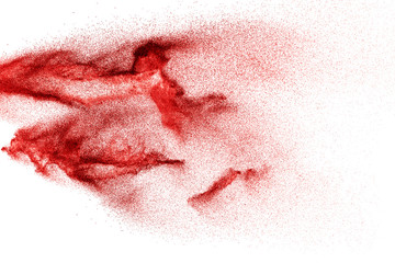 Red dust particles explosion on white background.Red sand splatter.