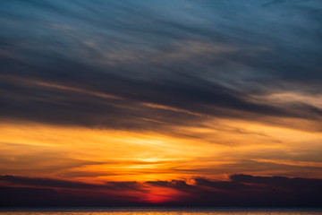 Obraz na płótnie Canvas cloudscape golden sky on the sea in summer time