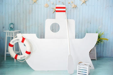 Big wooden ship background. Decor in style of sea travel. Sea thematic photo session decoration of daylight studio.