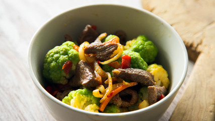 Beef with vegetables in a blue dish