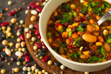 
Cooked mixed legumes beans lentils stew with tomatoes , vegan comfort food