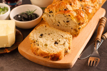 
Rustic traditional olives and spring onion bread, close up