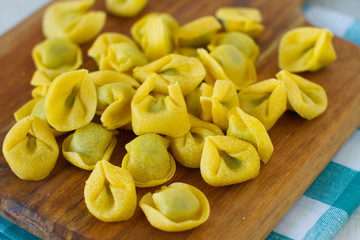 
Fresh spinach and ricotta tortellini on a rustic table