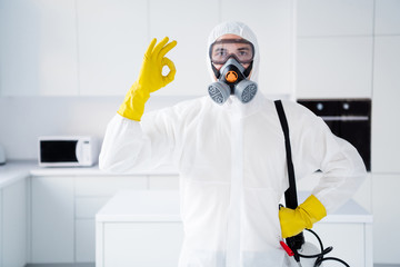 Portrait of confident guy show okay sign latex gloves recommend excellent quality stop spreading ncov epidemic treatment in house kitchen indoors