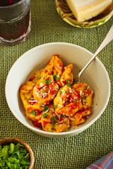 Fresh spinach and ricotta tortellini with tomato sauce, parmesan cheese and parsley on rustic table