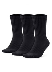 Three black socks isolated on white background. Three pair of socks. Set of short socks for sports on invisible foot as mock up for advertising, branding, design.