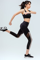 african american girl in sportswear running isolated on white