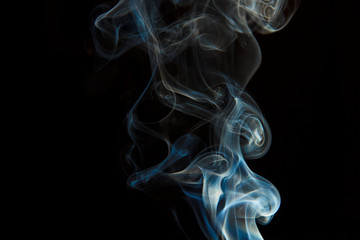 Smoke from an extinct candle on a black background