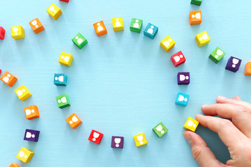 image of colorful blocks with people icons over wooden table ,human resources and management concept